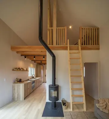 a loft conversion with a wood stove in a room at The Klover in Logan