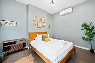 a bedroom with a large bed with white sheets at Free Downtown Parking Walk to Stadiums and Shopping in Covington