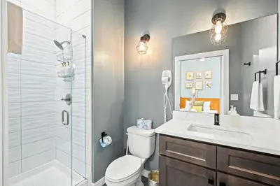 a bathroom with a shower and a toilet and a sink at Free Downtown Parking Walk to Stadiums and Shopping in Covington