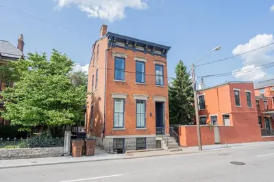 a red brick building on the corner of a street at Free Downtown Parking Walk to Stadiums and Shopping in Covington