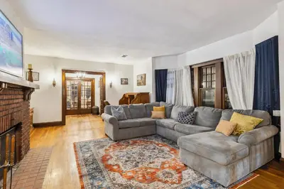 a living room with a couch and a fireplace at Steps to Edgewater - Sleeps 14 - Fun Game Room Retreat in Cleveland