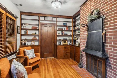 a living room with a brick wall and a fireplace at Steps to Edgewater - Sleeps 14 - Fun Game Room Retreat in Cleveland