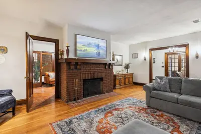 a living room with a fireplace with a tv on top at Steps to Edgewater - Sleeps 14 - Fun Game Room Retreat in Cleveland