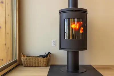 a black fireplace in the corner of a room at The Ffern in Logan