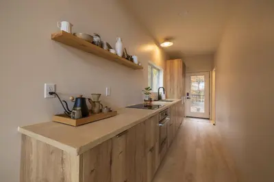 a kitchen with wooden cabinets and a counter top at The Ffern in Logan