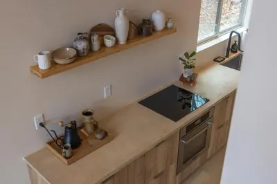 a kitchen with wooden cabinets and a counter top at The Ffern in Logan