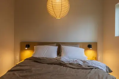 a bedroom with a bed with two pillows and a lamp at The Ffern in Logan