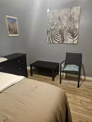 a bedroom with a bed and a painting of zebras at Family size house in Reynoldsburg