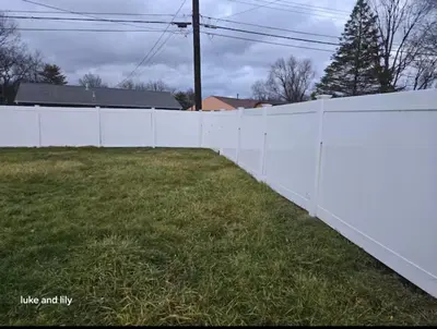 a white fence in a yard with grass at Family size house in Reynoldsburg