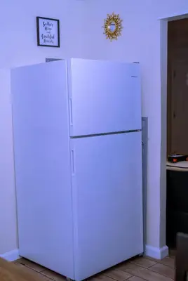 a white refrigerator with a sign on top of it at Family size house in Reynoldsburg