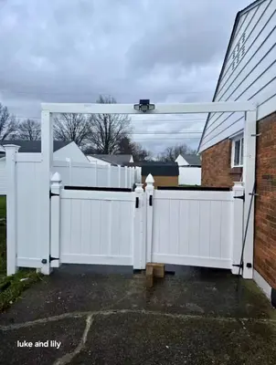 a white fence with a gate in front of a house at Family size house in Reynoldsburg