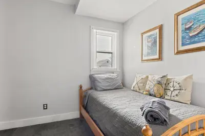 a small bedroom with a bed and a window at W38 Front in Cleveland