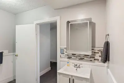 a bathroom with a sink and a mirror at W38 Front in Cleveland