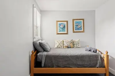 a bedroom with a bed and two pictures on the wall at W38 Front in Cleveland