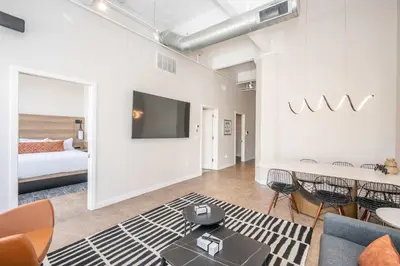 a living room with a couch and a tv at The 333 Suites - For 24 Guests in Cincinnati