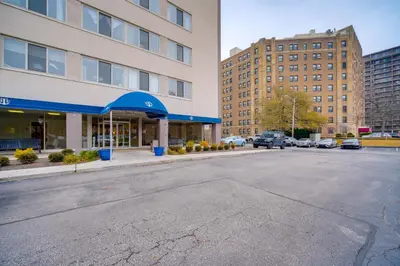 an empty street in a city with tall buildings at Cozy 12th-Floor Studio with Lake Erie Views! in Lakewood