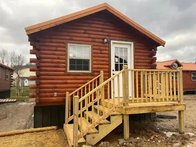 a log cabin with a ramp leading up to it at Wayne Cabin