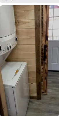 a washer and dryer in a kitchen with a wall at Wayne Cabin