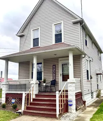 a white house with a red porch and stairs at 3 Bedroom Home, near downtown, Tremont, Ohio City! in Cleveland