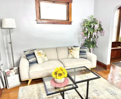 a living room with a couch and a glass table at 3 Bedroom Home, near downtown, Tremont, Ohio City! in Cleveland