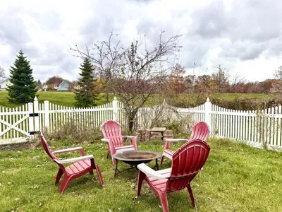 four chairs and a table in a yard with a fence at 3 Bedroom Home, near downtown, Tremont, Ohio City! in Cleveland