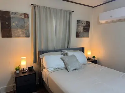 a bedroom with a bed with two lamps and a window at Perfect for Travel Nurses Quiet in Clarksburg