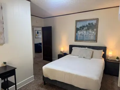 a bedroom with a large bed and two night stands at Perfect for Travel Nurses Quiet in Clarksburg