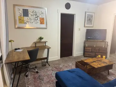 a room with a desk and a table and a tv at Perfect for Travel Nurses Quiet in Clarksburg
