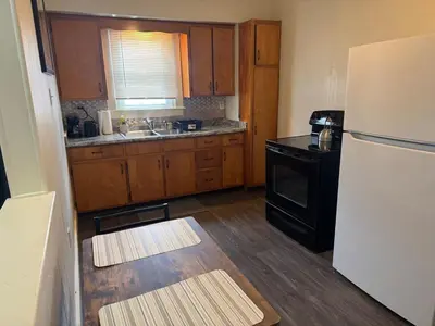 a kitchen with a white refrigerator and wooden cabinets at Perfect for Travel Nurses Quiet in Clarksburg