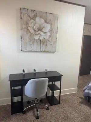 a desk with a chair and a painting on the wall at Perfect for Travel Nurses Quiet in Clarksburg