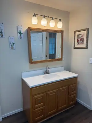 a bathroom with a sink and a mirror at Cozy 3 4 BR Home Ideal for Family in Clarksburg