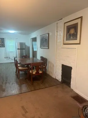 a dining room with a table and a fireplace at Cozy 3 4 BR Home Ideal for Family in Clarksburg