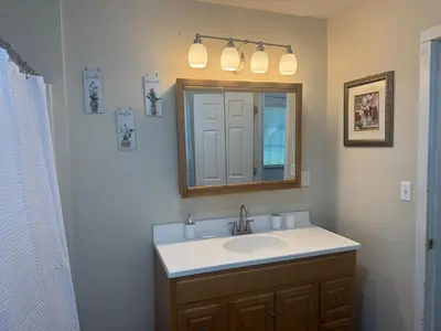 a bathroom with a sink and a mirror at Cozy 3 4 BR Home Ideal for Family in Clarksburg