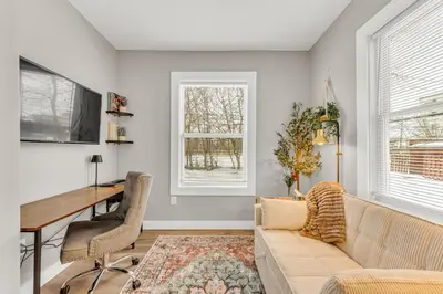 a living room with a couch and a desk at Family-owned 3BR in Larchmere Near Hospitals with Parking in Cleveland