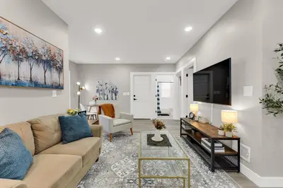 a living room with a couch and a tv at Family-owned 3BR in Larchmere Near Hospitals with Parking in Cleveland