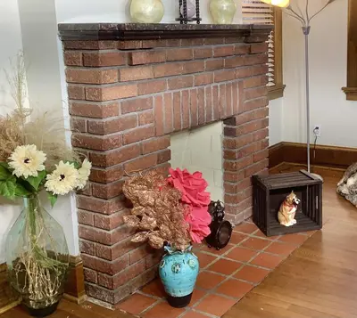 a brick fireplace with a cat sitting in a niche at 2 bedroom Loft apartment near downtown, Ohio city, Tremont! in Cleveland