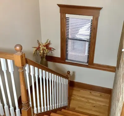 a staircase with a window and a vase of flowers at 2 bedroom Loft apartment near downtown, Ohio city, Tremont! in Cleveland