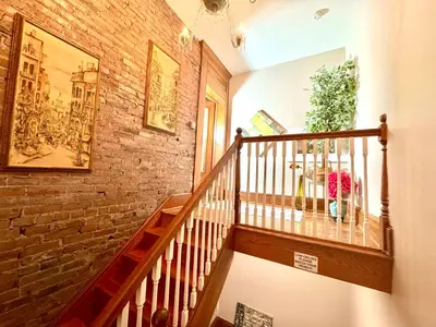a staircase in a building with a brick wall at 2 bedroom Loft apartment near downtown, Ohio city, Tremont! in Cleveland