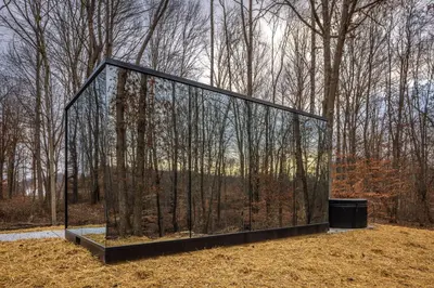 a glass box in the middle of a forest at The Mirage Escape in New Plymouth