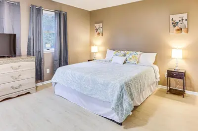 a bedroom with a large bed and a television at Inviting Family Home, 2 Mi to Eastwood Mall! in Niles
