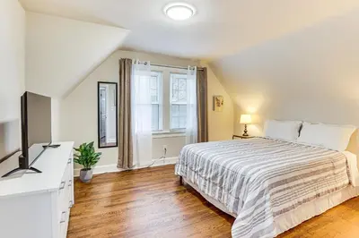 a bedroom with a large bed and a window at Inviting Family Home, 2 Mi to Eastwood Mall! in Niles