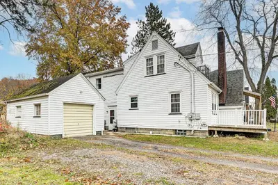 an old white house with a porch at Inviting Family Home, 2 Mi to Eastwood Mall! in Niles