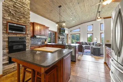 a kitchen with an island in the middle of a room at Giant Property w Sledding Hills and Golf in Logan