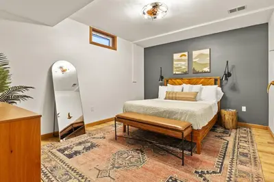 a bedroom with a bed and a rug at Giant Property w Sledding Hills and Golf in Logan