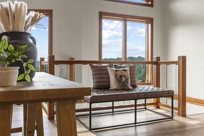 a dog sitting on a bench in a living room at Giant Property w Sledding Hills and Golf in Logan
