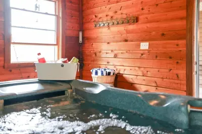 a bath tub in a wooden bathroom with a window at Giant Property w Sledding Hills and Golf in Logan