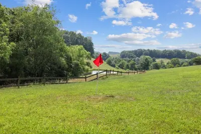 a red flag in the middle of a field at Giant Property w Sledding Hills and Golf in Logan