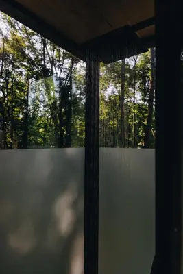 a window in a room with trees in the background at The Illusion Hideaway in New Plymouth