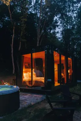 a small tent with a bed in it at night at The Illusion Hideaway in New Plymouth