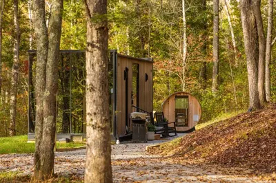 a tiny house in the woods with a bench at The Illusion Hideaway in New Plymouth